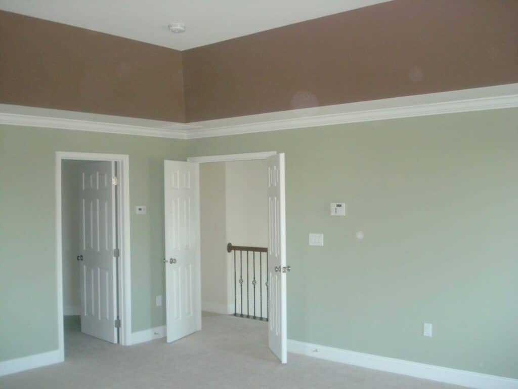 pale green and taupe wall with custom white molding, molding and trim work, trucare painters