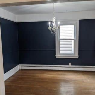dining room with dark blue walls and white trim, interior painting, trucare painters