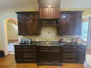 expresso ktichen cabinets above stove with decorative feature, cabinet painting, kitchen cabinet refinishing, trucare painters